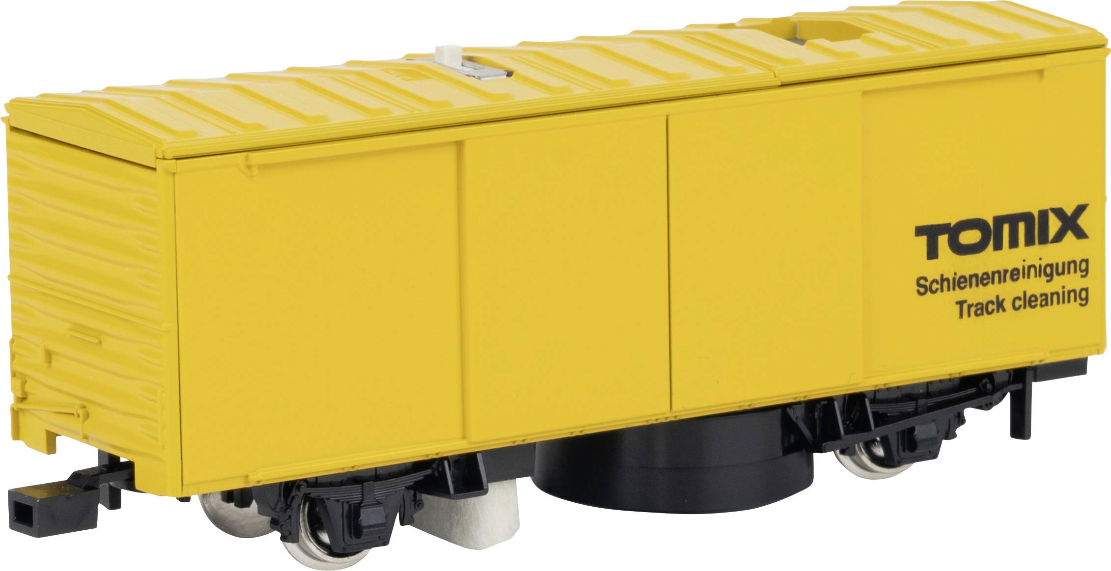 Žlutý čisticí vůz pro modelové kolejiště s nápisem 'Tomix Schienenreinigung Track cleaning', určený k čištění kolejí modelových železnic.