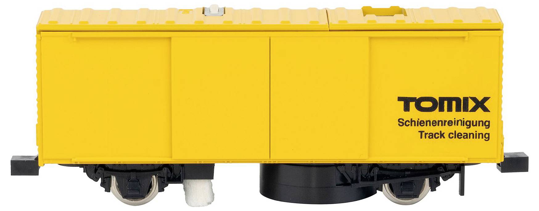 Žlutý model vlakové vozu označený 'TOMIX Track cleaning'.