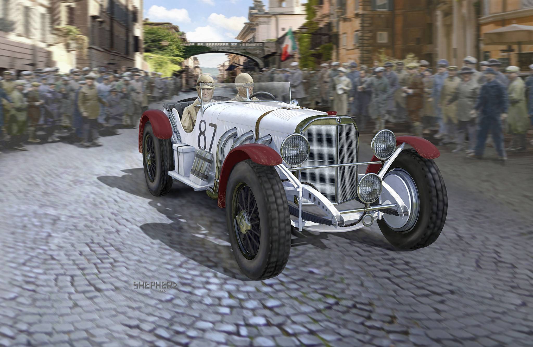 Historické auto s číslem 87 projíždí během závodu živou dlážděnou ulicí obklopené davem lidí.