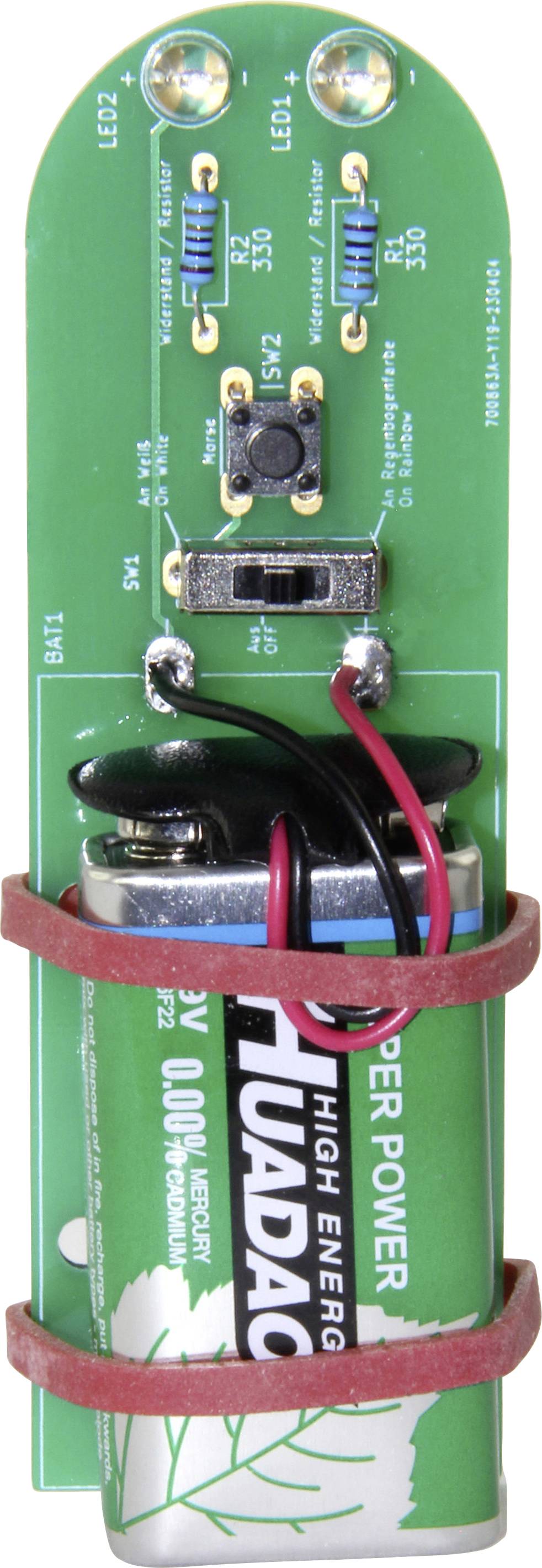 Zelená deska plošných spojů s namontovanou baterií, elektronickými komponenty a spoji; zobrazuje malou elektrickou jednotku.