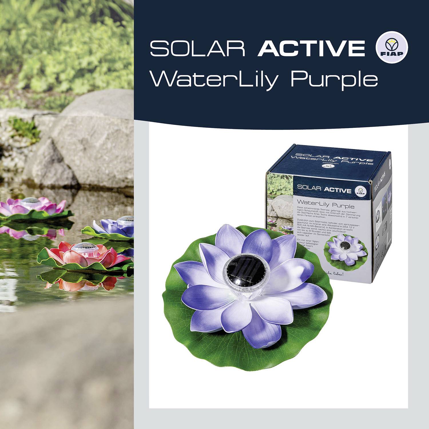 Dekorace 'Solar Active WaterLily Purple' v zahradním rybníčku vedle kamenů a zelené vegetace. Obal produktu je viditelný.