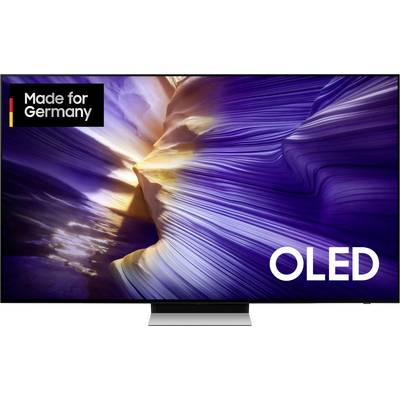 Televizor s reklamou 'Made for Germany' a 'OLED'. Zobrazuje dynamický, barevný obraz se světelnými paprsky na vlnitém pozadí.