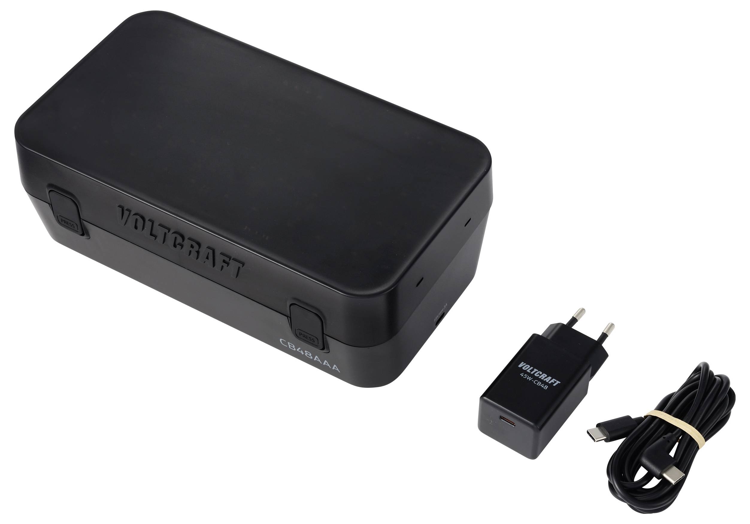 Černá obdélníková chytrá nabíječka na hodinky v krabici se síťovým adaptérem a USB kabelem na bílém pozadí.