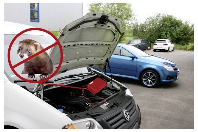 Automobil se zvednutou kapotou ukazující součásti motoru, překryto přeškrtnutou norkou signalizující antiproticovné odrazovací zařízení. Nedaleko jsou zaparkována dvě vozidla.