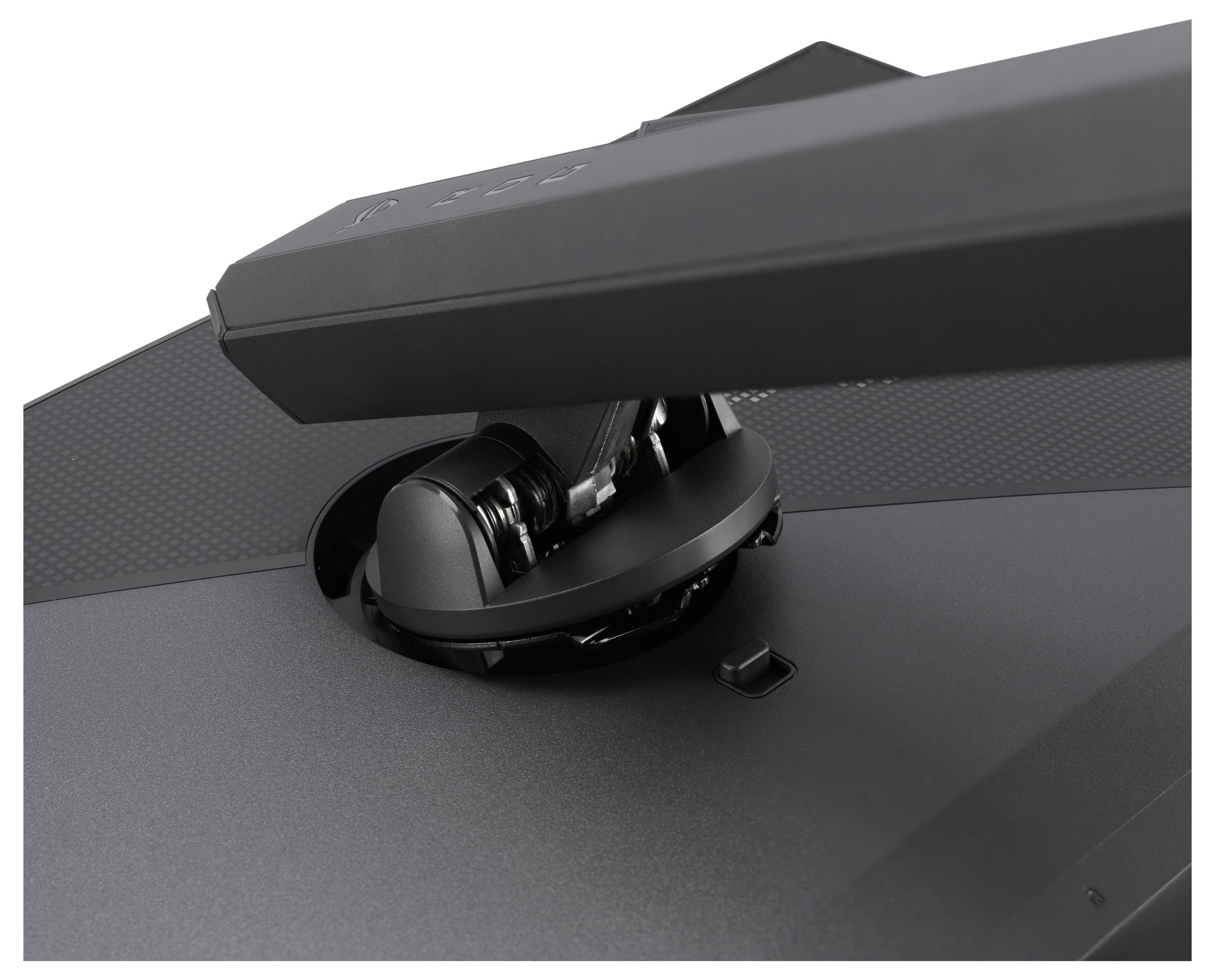 Detailní pohled na šedou základnu monitoru, zobrazující její upevňovací mechanismus a nastavitelné rameno. Povrch je hladký a kovový.