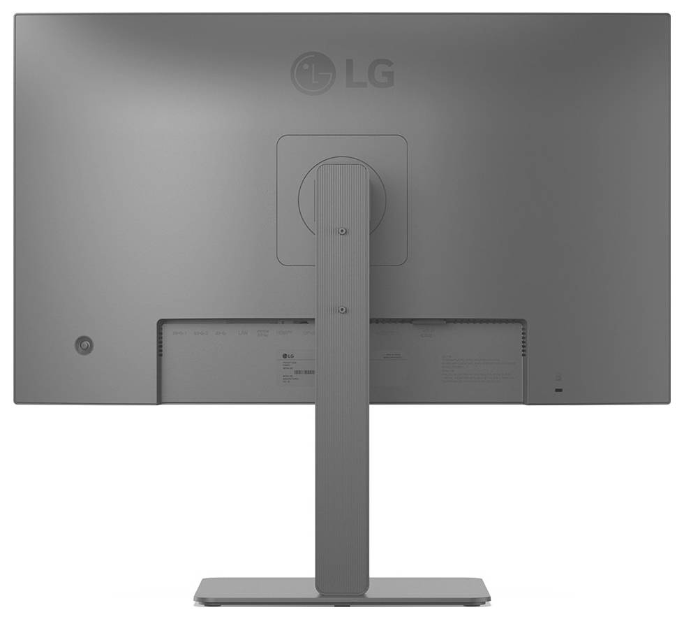 Zadní pohled na počítačový monitor LG umístěný na stojanu, s hladkým šedým zadním panelem s větracími otvory a štíhlým podpůrným ramenem.