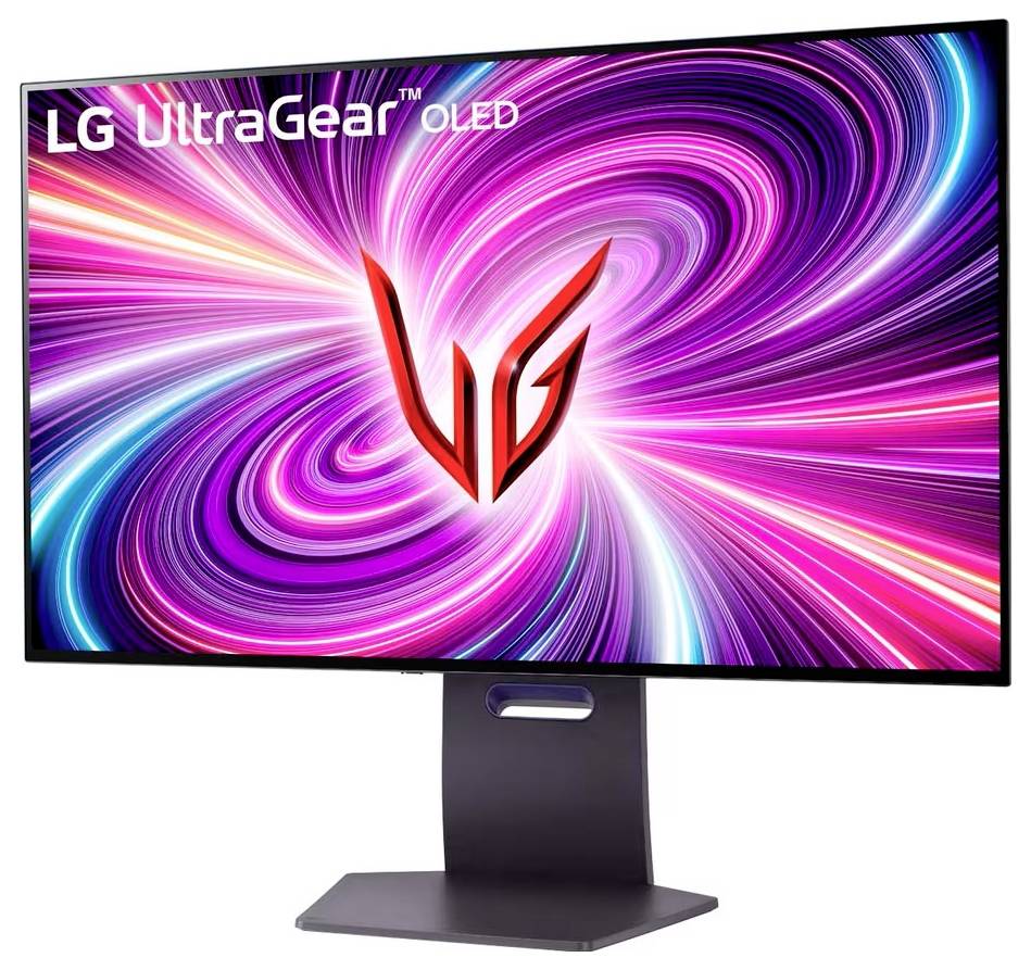 Monitor zobrazující živý, barevně proměnlivý spirálový vzor s logem 'LG UltraGear OLED' v levém horním rohu a velkým červeným stylizovaným písmenem 'V' uprostřed.