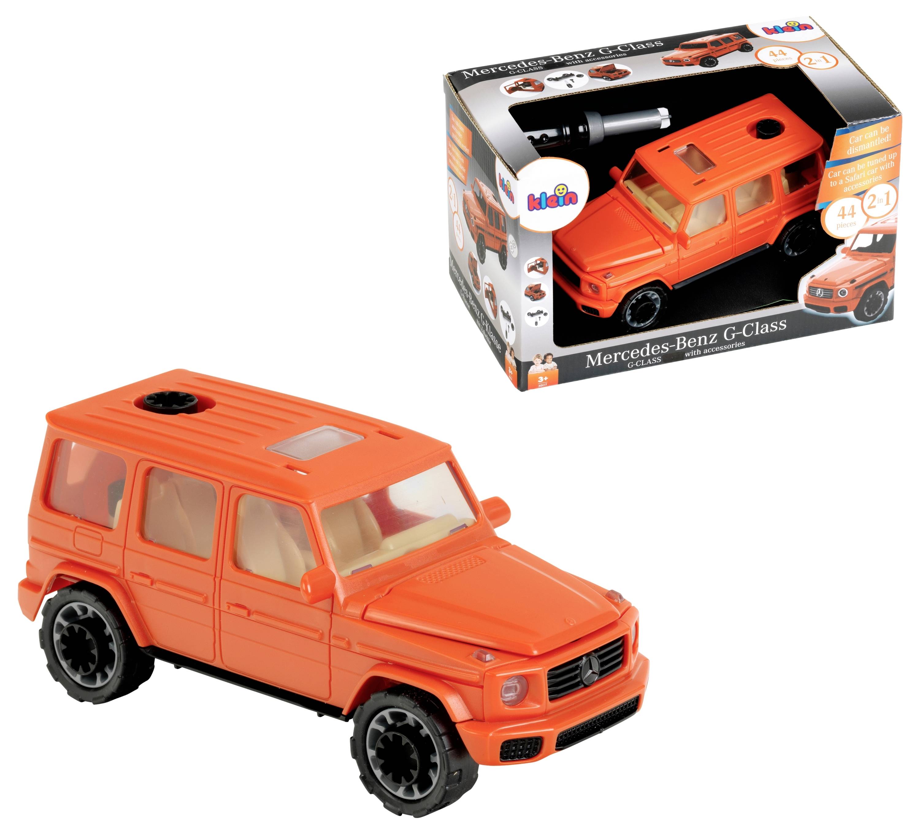 Oranžový model Mercedes-Benz G-Class vedle svého originálního obalu, který zobrazuje podobné vozidlo s firemním označením a návodem.