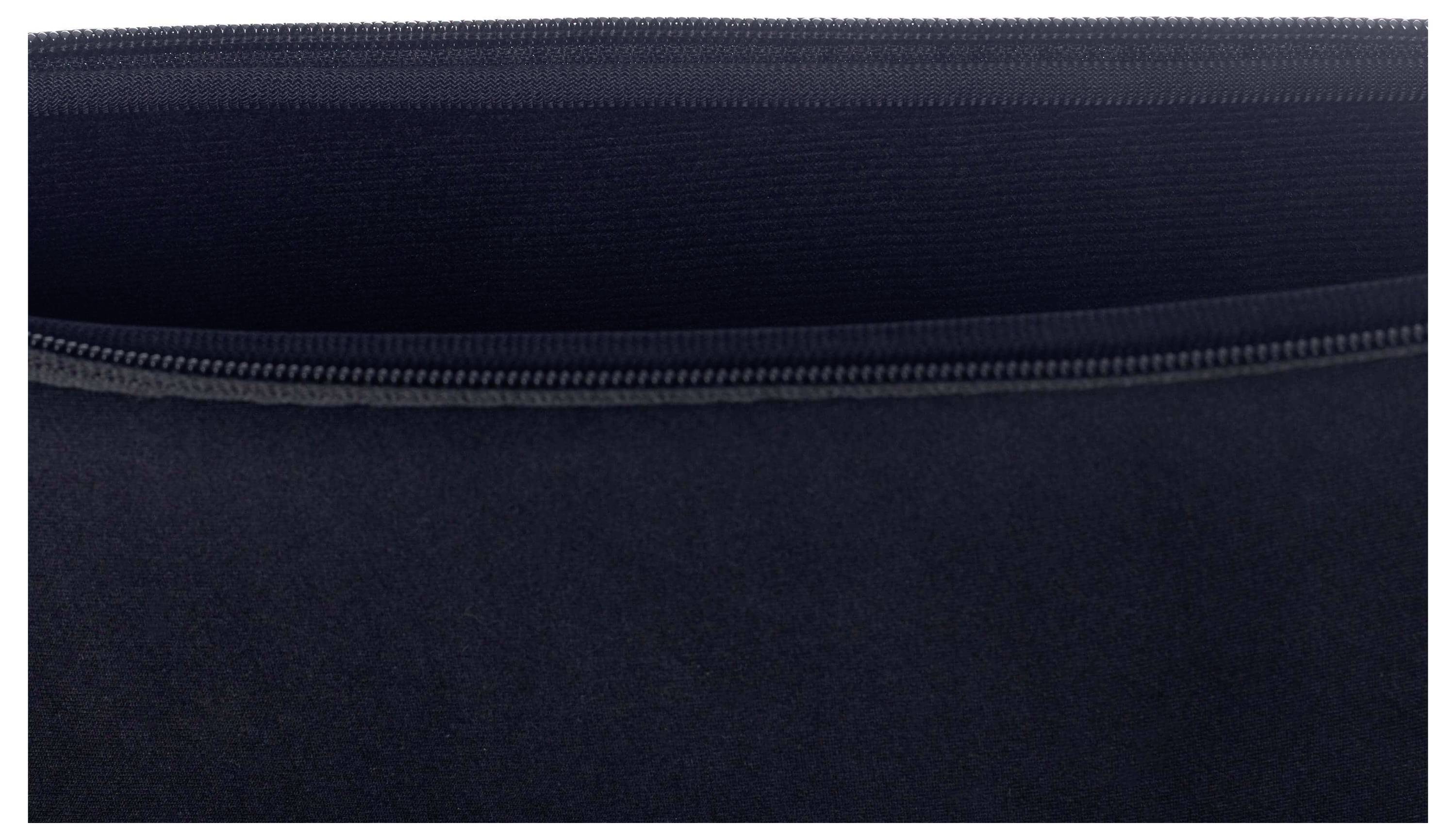 Detailní pohled zblízka na černý zip, částečně rozepnutý, odhalující detail zubů a látky.