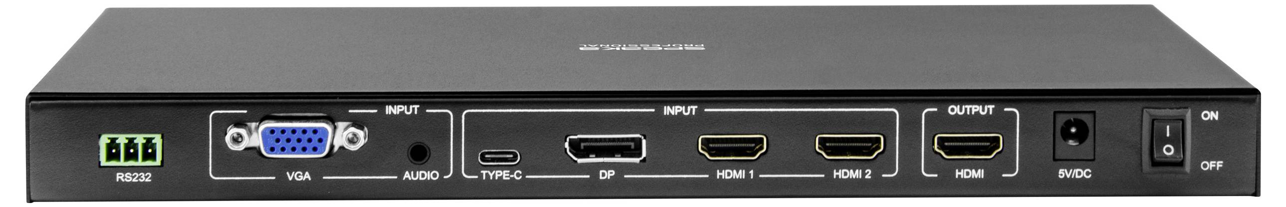 Černé elektronické zařízení s různými vstupními a výstupními porty včetně VGA, HDMI, USB-C a zvukového portu. Vypínač je umístěn v pravém dolním rohu.