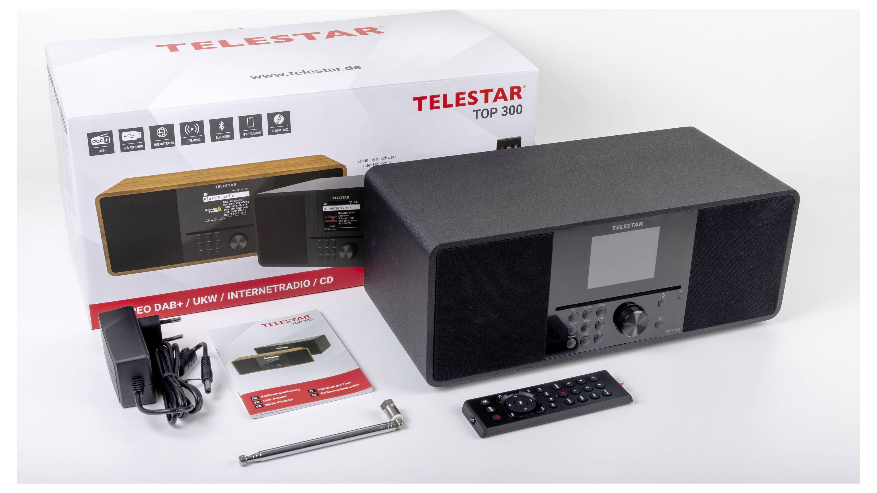 Audiosystém 'Telestar Top 300' s krabicí zobrazující různé funkce. Obsahuje dálkový ovladač, napájecí adaptér a antény.