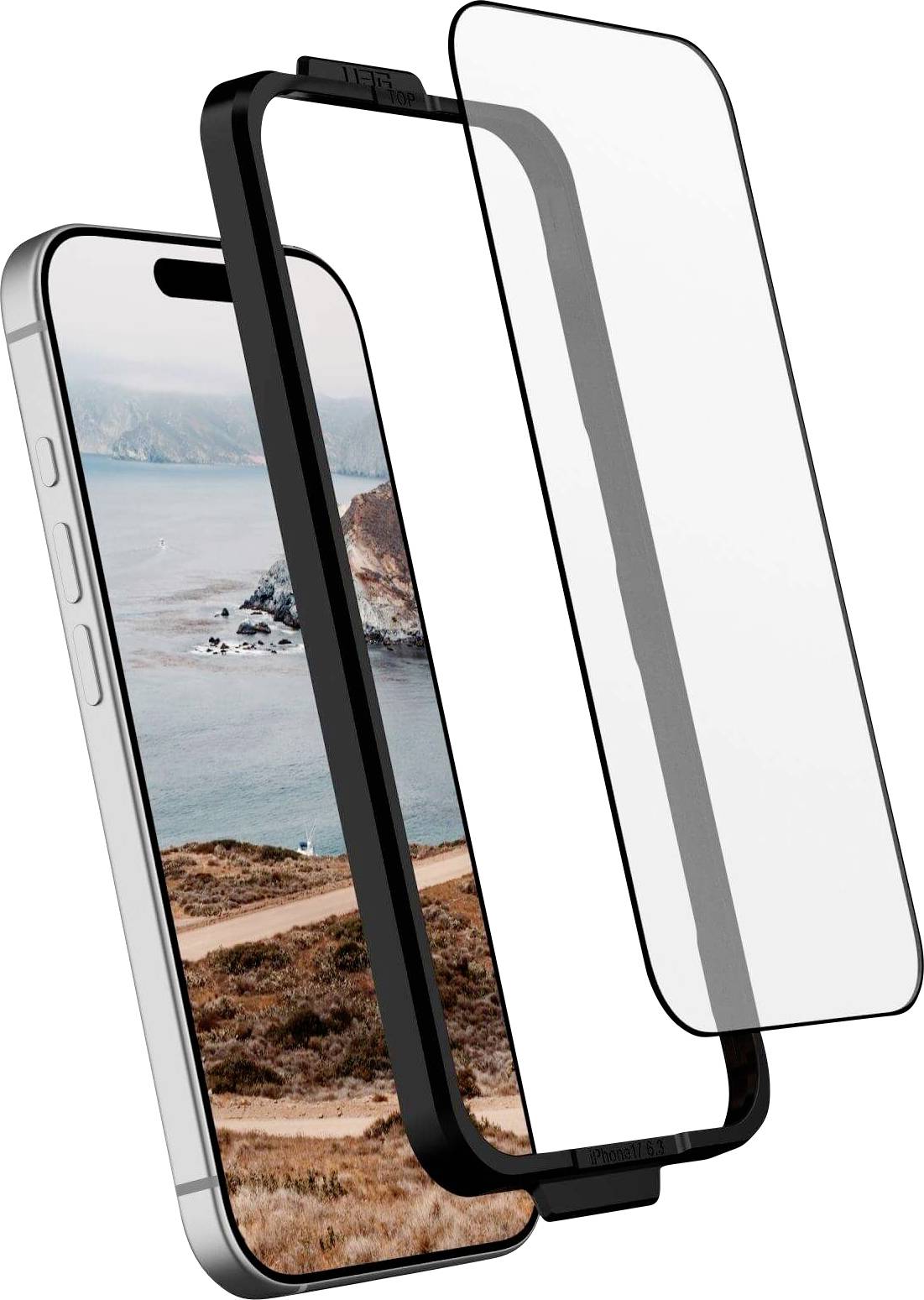 Chytrý telefon s nástěnnou tapetou zobrazující scenérii pobřeží je zachycen s odpojitelným ochranným sklem s černým okrajem, které visí nad zařízením.