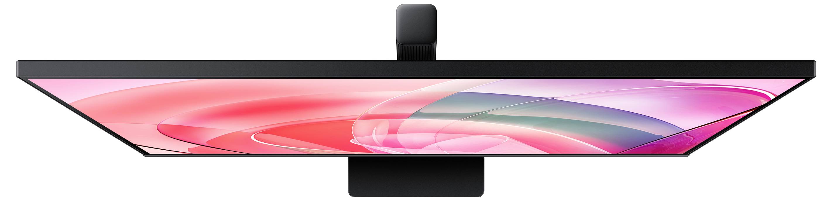 Štíhlý, mimořádně tenký monitor, pohled shora, zobrazující živý abstraktní design v růžových a červených tónech na obrazovce.