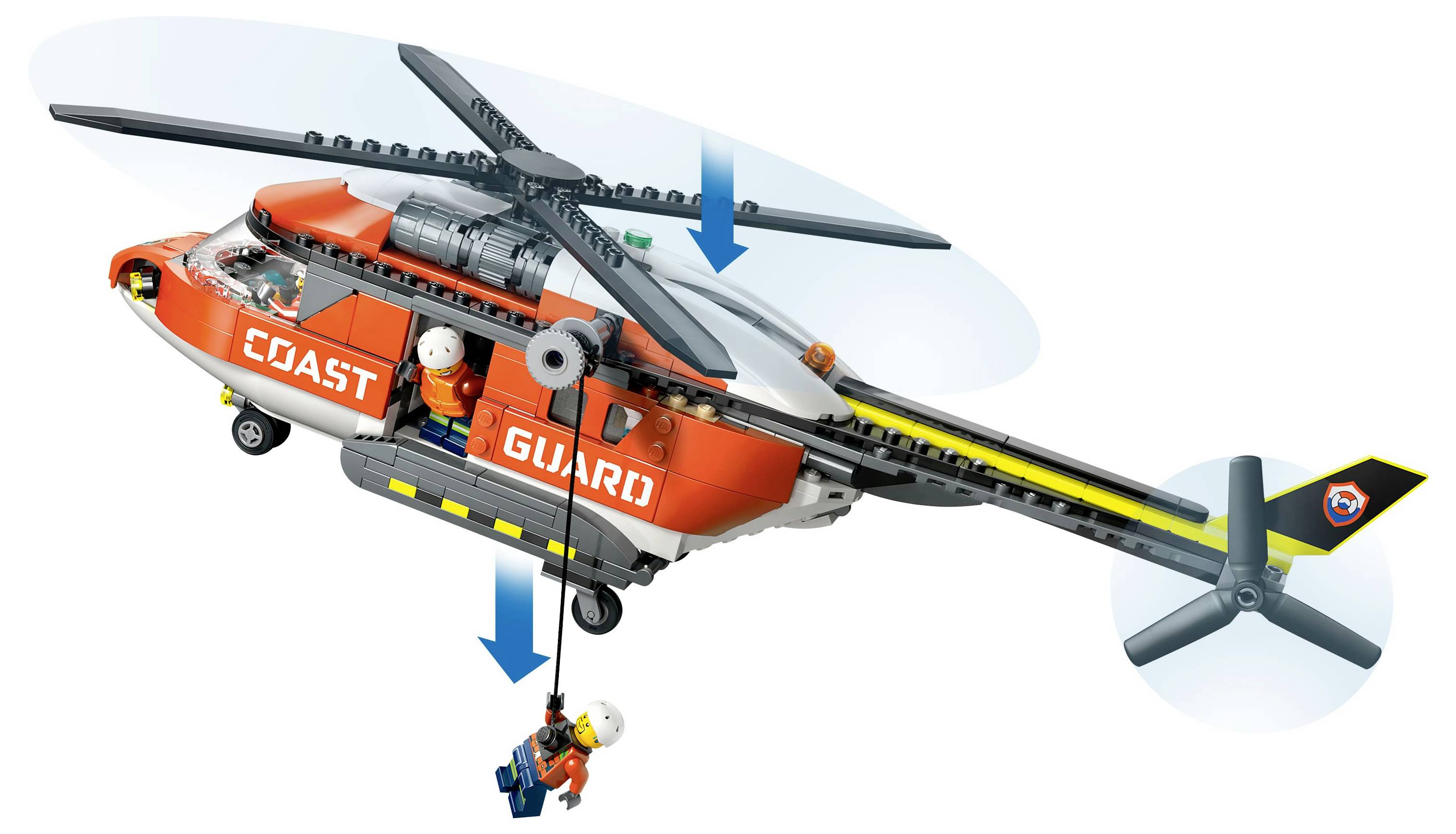 Hračkářská helikoptéra označená nápisem "Pobřežní stráž" s figurkou záchranáře spouštějícího osobu na laně, znázorňující záchrannou operaci.