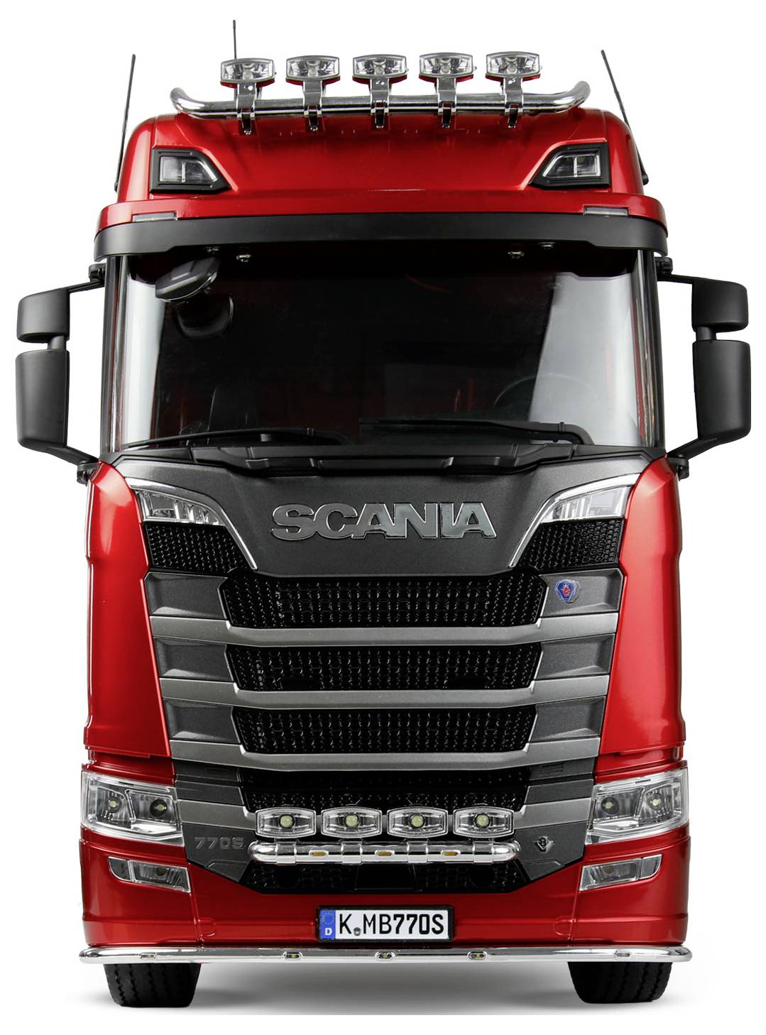Červený tahač Scania pohledem zepředu, zobrazující jeho charakteristickou mřížku chladiče, světlomety a vyzdvižená světla na střeše.