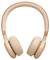 Béžové over-ear sluchátka s čalouněnou látkou potaženou hlavovou páskou, zobrazená na bílém pozadí.