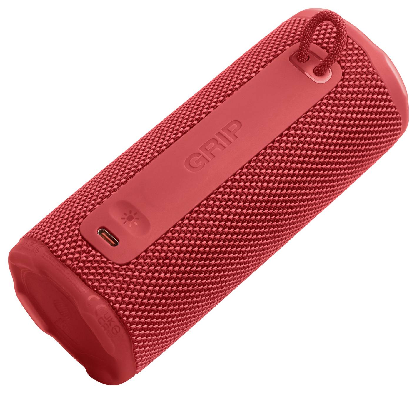 Červený, přenosný bluetooth reproduktor s texturovanou rukojetí a nabíjecím portem, navržený pro snadné nošení a venkovní použití.