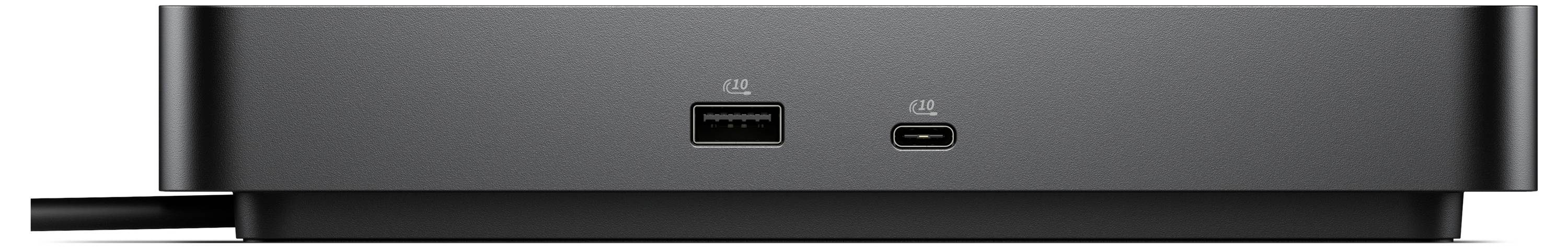 Detail šedého elektronického zařízení s porty USB-C a USB umístěného na hladkém povrchu.