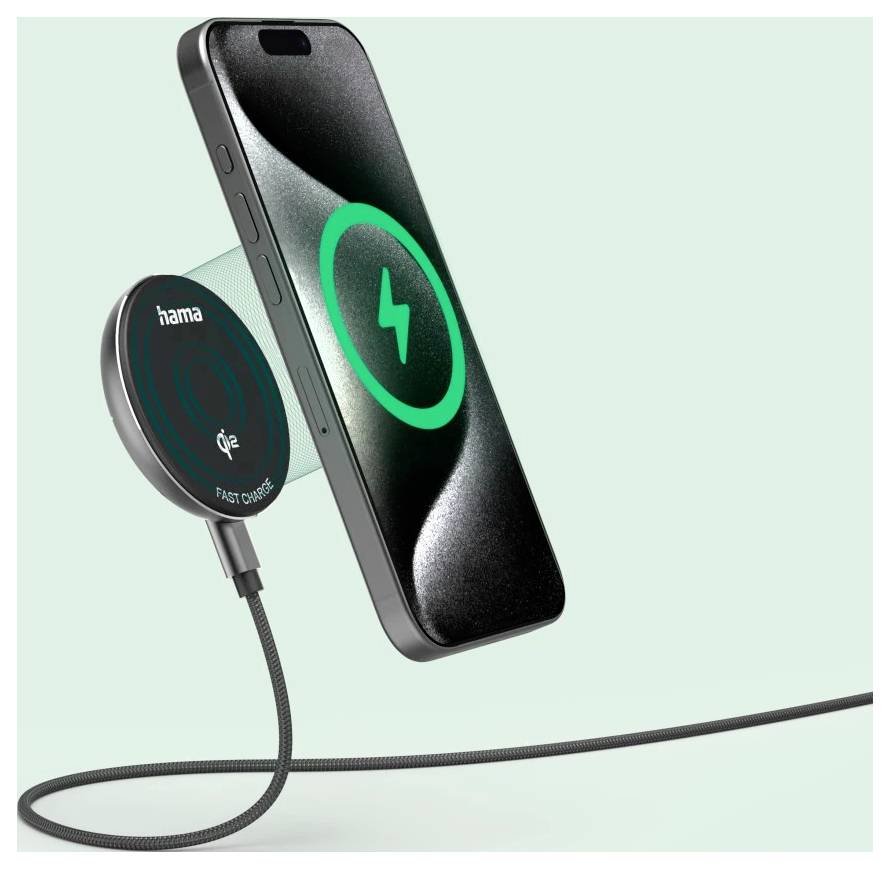 Smartphone visící nad bezdrátovou nabíječkou s zeleným nabíjecím symbolem na displeji, což signalizuje probíhající bezdrátové nabíjení.