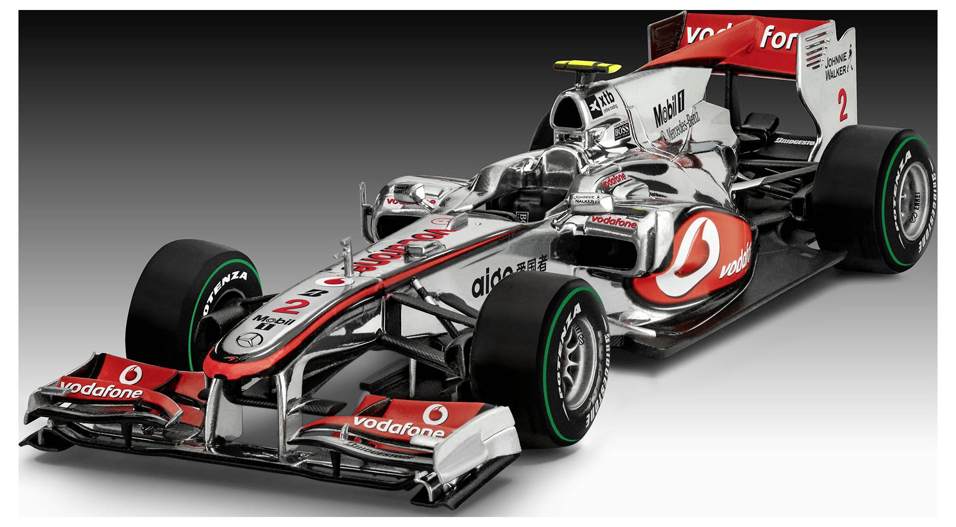 Elegantní monopost Formule 1 v červené a šedé barvě, s číslem '2' na kapotě a výrazným logem Vodafone.