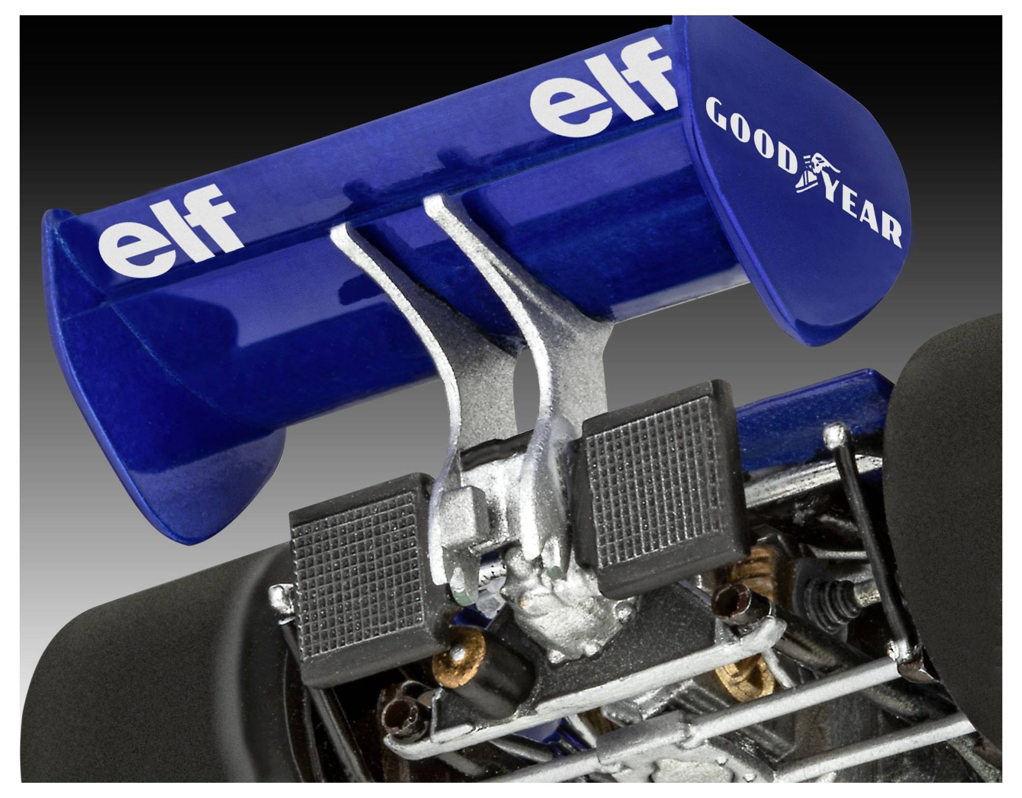 Zadní křídlo a komponenty zavěšení závodního vozu z doby klasických motorsportů. Modré křídlo s logy 'elf' a 'Goodyear', viditelné propracované mechanické detaily.