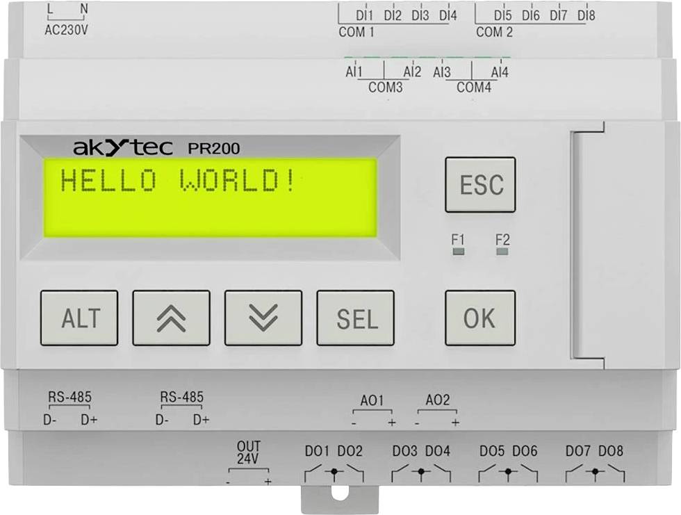 Obrázek zobrazuje digitální displej ovladače s nápisem 'HELLO WORLD!' na obrazovce, obklopený různými tlačítky a připojovacími porty.