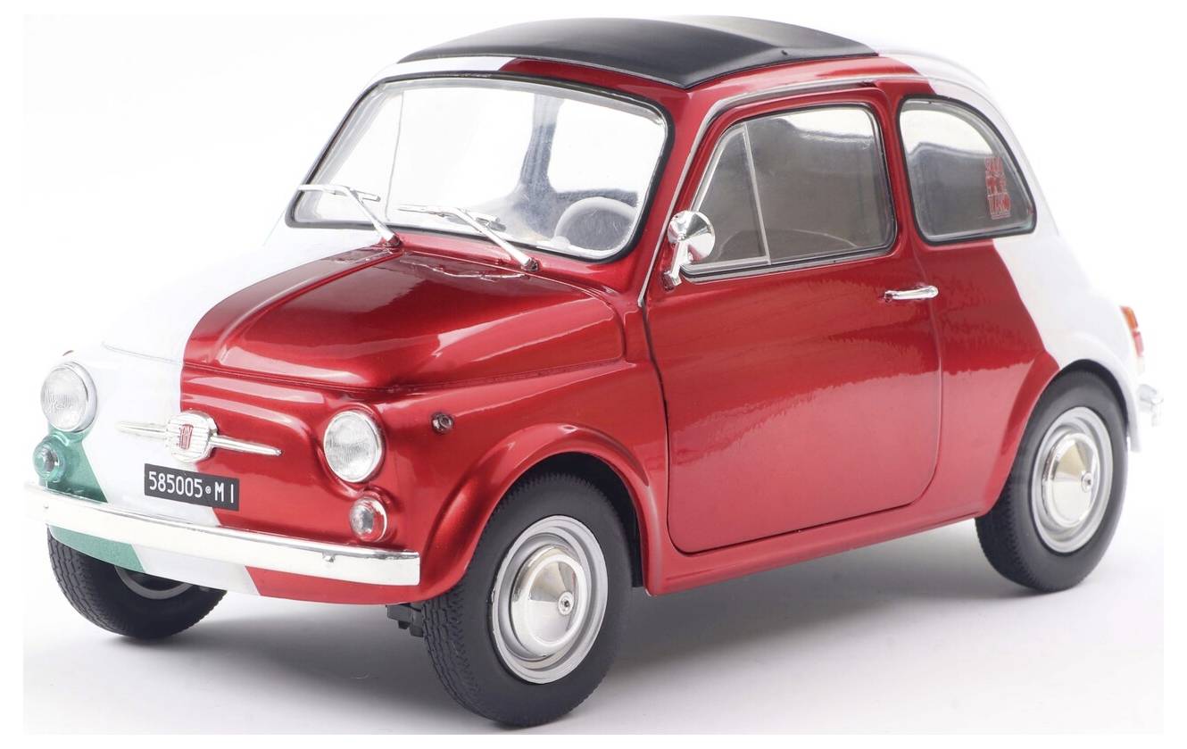 Vintage červeno-bílé kompaktní auto se stříbrným lemováním a kulatými světlomety, umístěné na bílém povrchu.