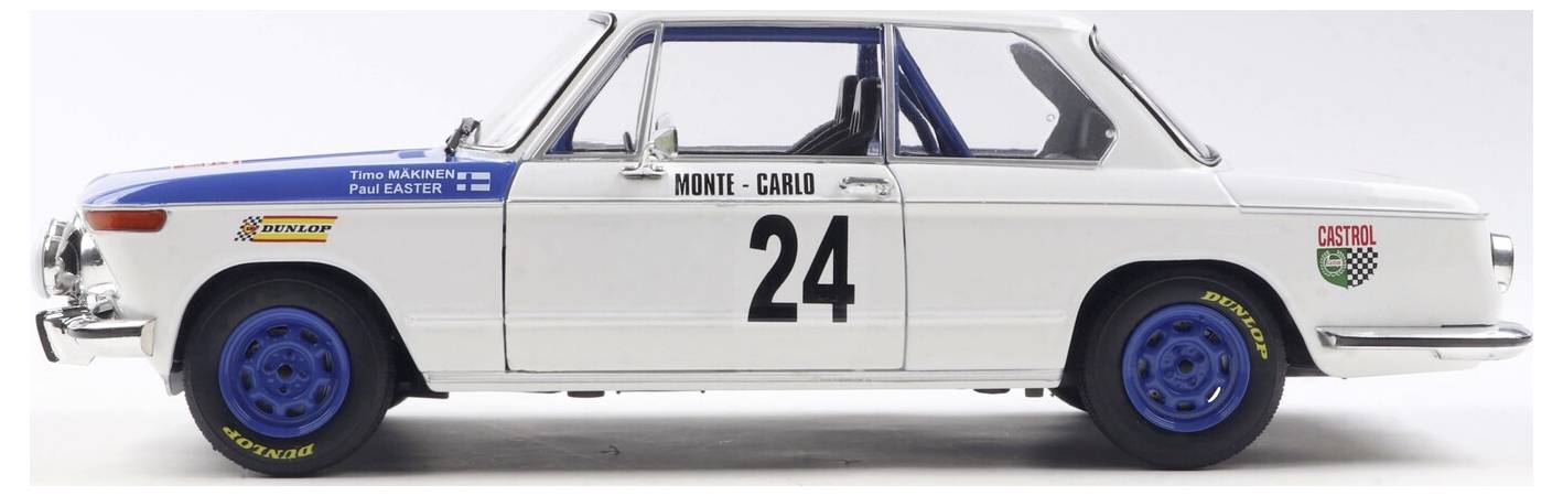 Model auta klasického rallye vozu v bílé barvě s modrými koly, s číslem '24' a nápisem 'Monte-Carlo' na boku.