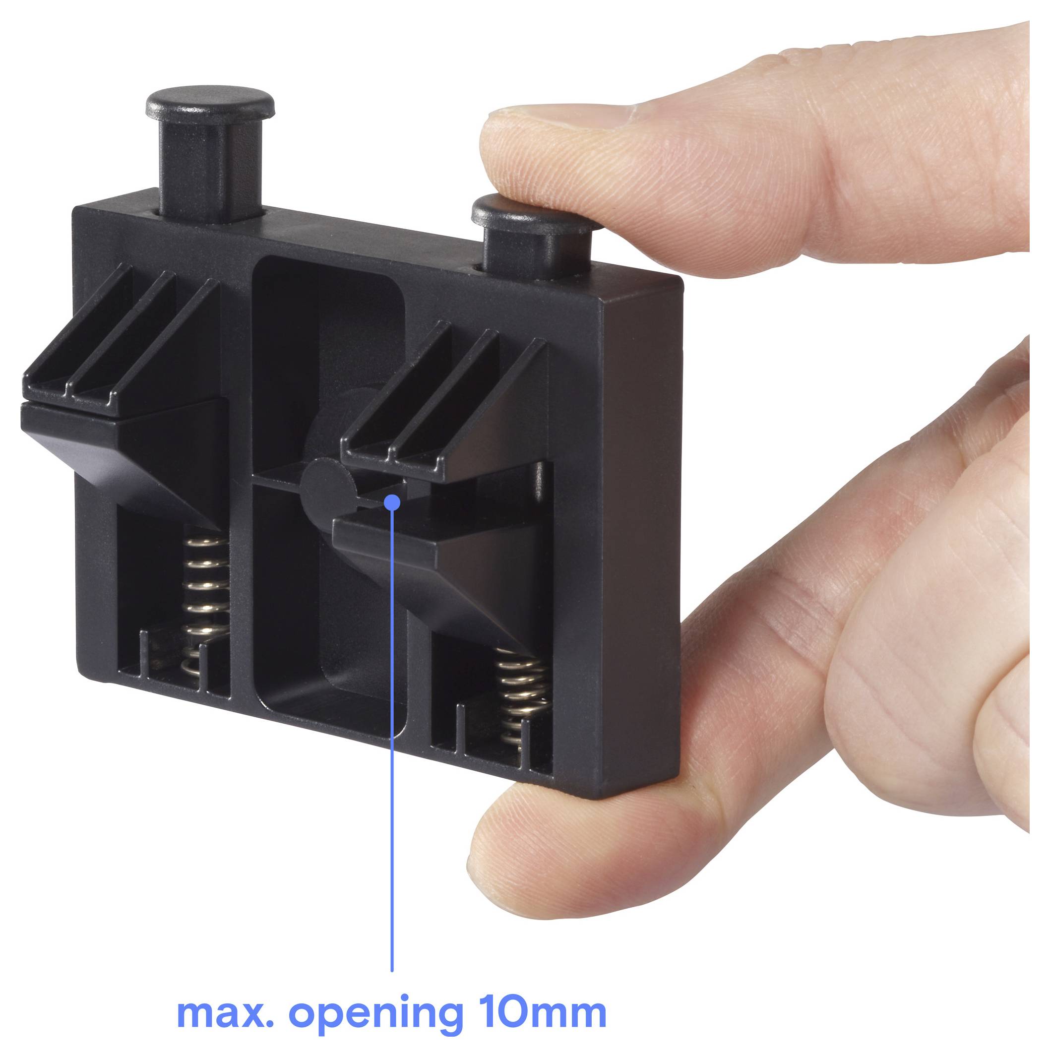 Ruka drží černý nástroj se dvěma pružinami a nastavitelnými svorkami, označený „max. otevření 10 mm" s modrou čarou označující měření.