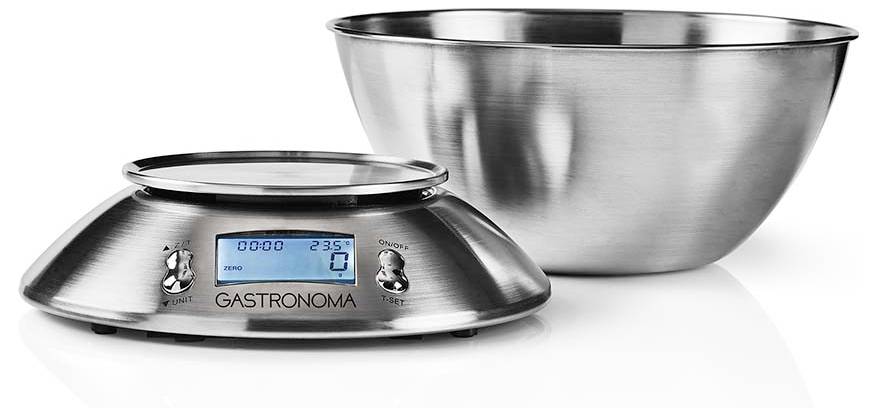 Digitální kuchyňská váha z nerezové oceli s mísou, s modrým LCD displejem. Váha ukazuje 0 gramů a 23% úroveň nabití baterie.