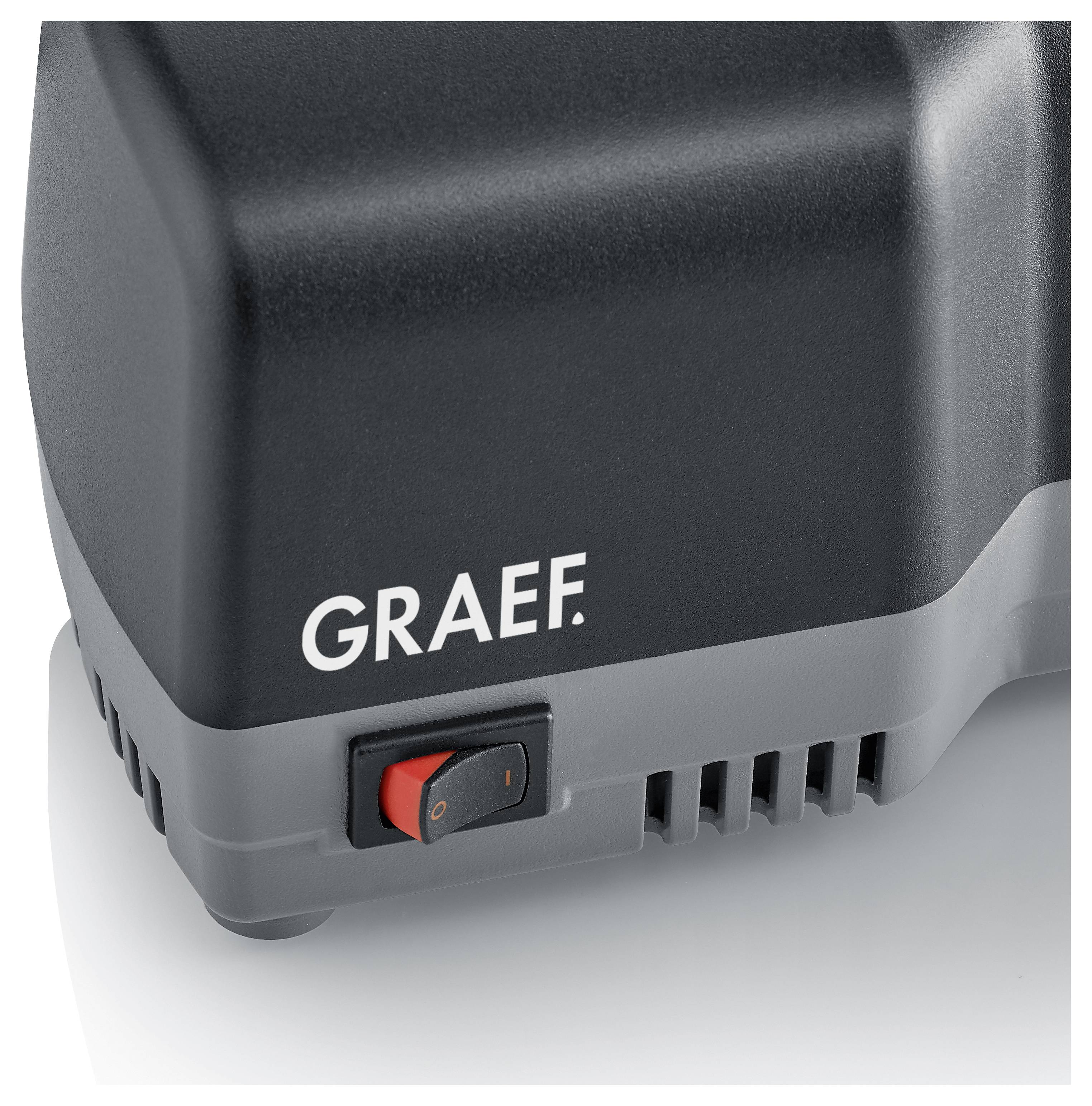 Elektrické zařízení s logem 'Graef' a červeným vypínačem, zobrazené z blízkého úhlu.