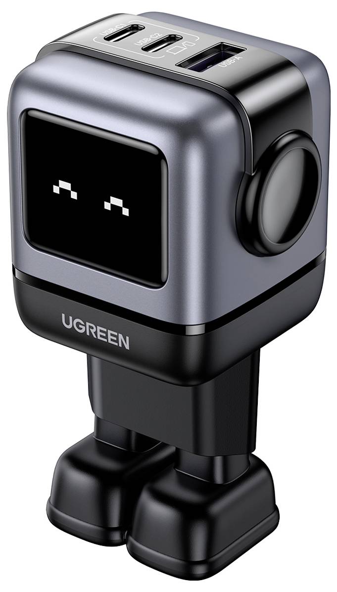 Kompaktní nabíjecí adaptér v podobě robota s více USB porty na horní straně, s označením značky „UGREEN" na přední straně, vybavený hravým displejem tváře.