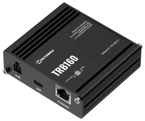 Černé síťové zařízení označené "TELTONIKA TRB160" s konektory Ethernet, USB a napájením, navržené pro řešení konektivity.