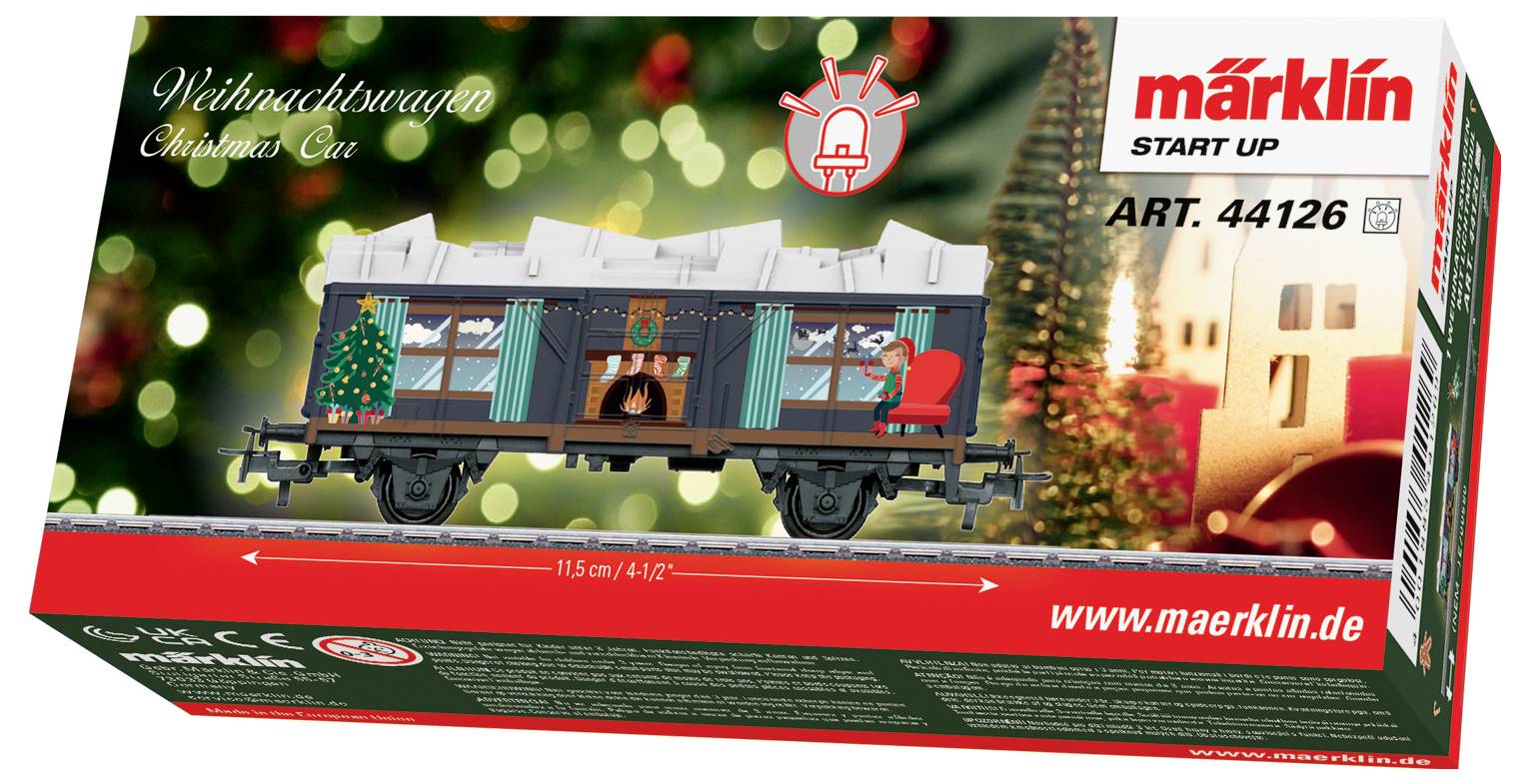 Krabice modelového vlaku "Vánoční vůz" s ozdobeným osobním vagonem na pozadí s vánočním motivem, označena Märklin Start Up, ART. 44126.
