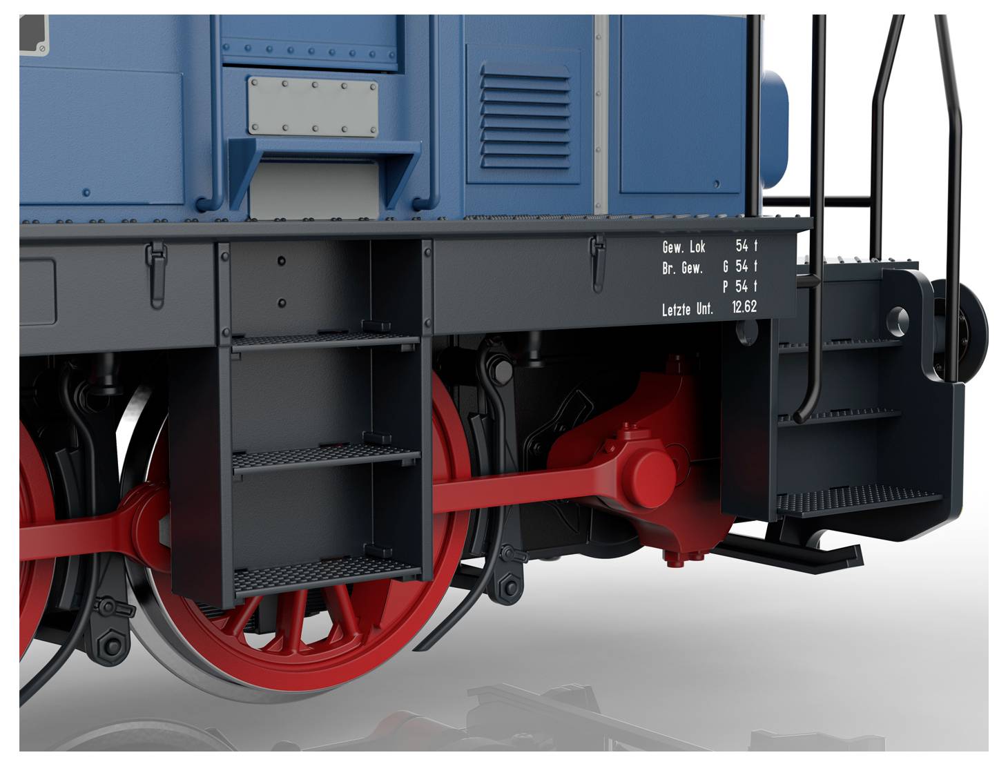 Modelový vagon s červeným tělem, označený „Deutsche Bundesbahn" a šedou střechou, je vystavený na kolejích.