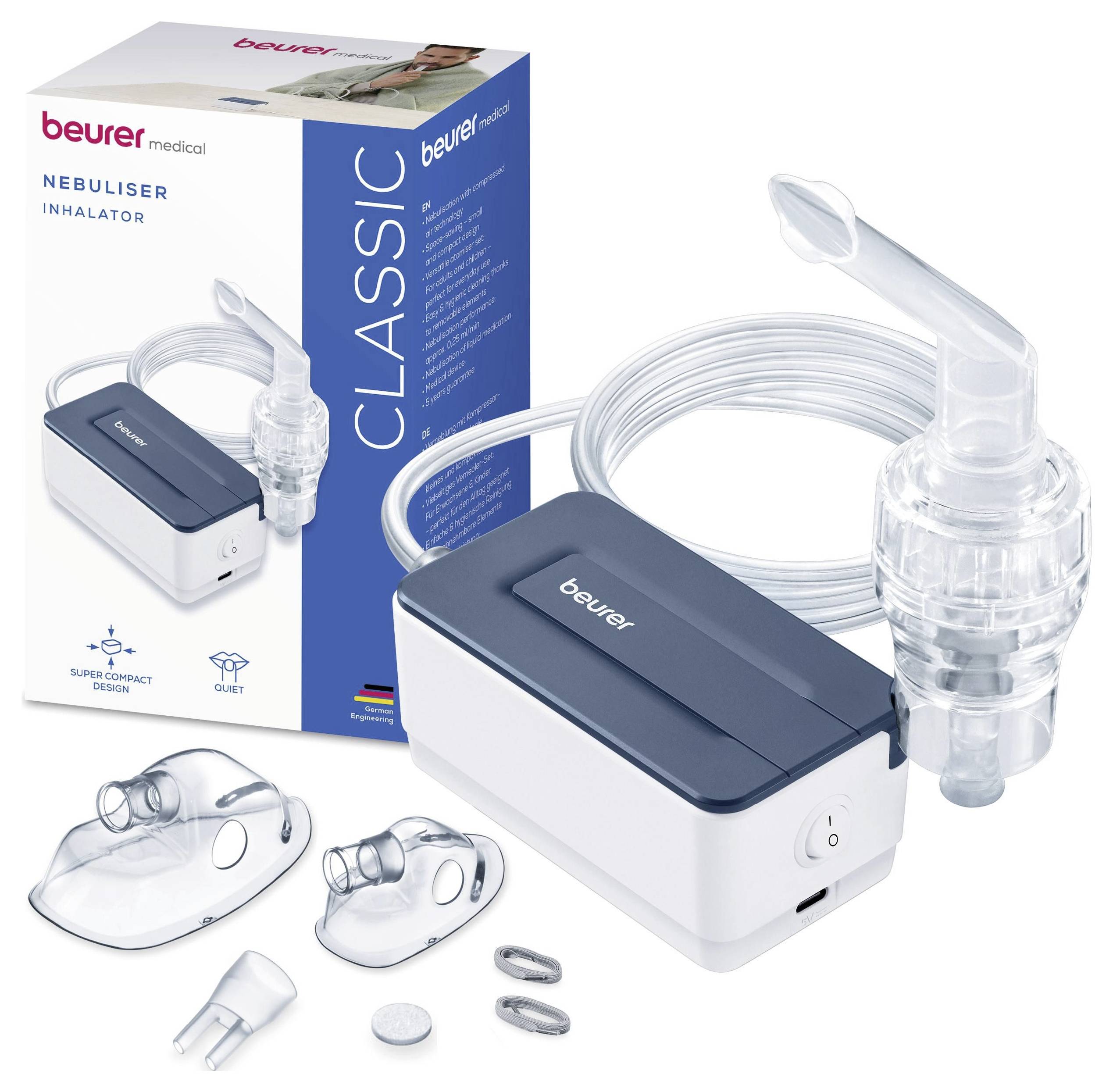 Kompaktní bílý a modrý inhalátor s náustky, maskami a hadičkami vedle jeho balení označeného "Beurer Classic Nebuliser Inhalator".
