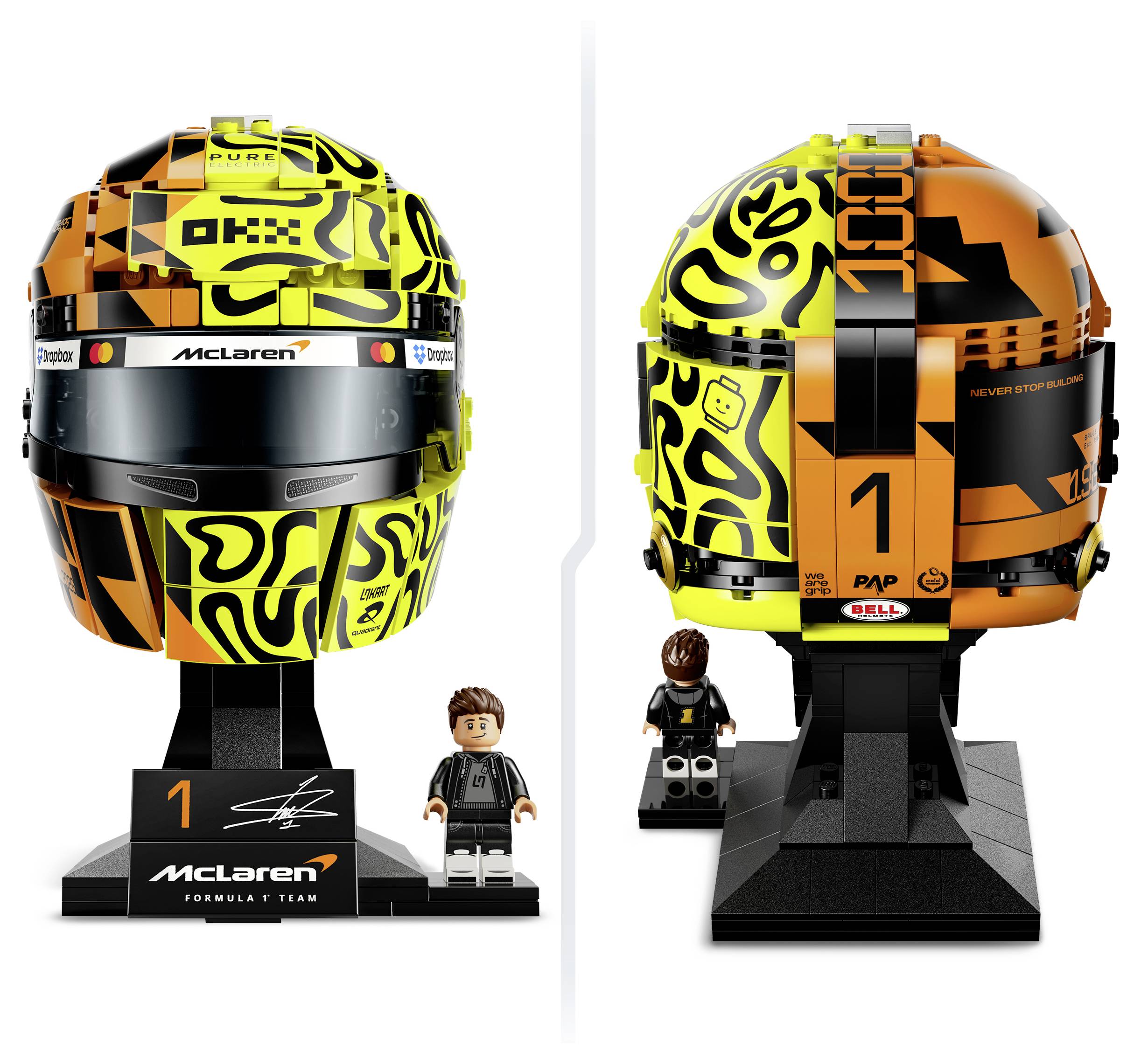 Přední a zadní pohled na přilbu McLaren Formule 1 na stojanu, včetně figurky ve stylu LEGO; livery v černé, žluté a oranžové barvě s číslem 1.