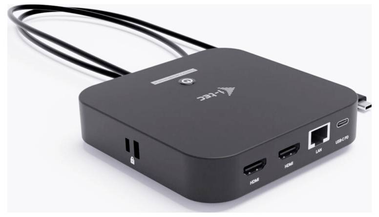 Černá elektronická dokovací stanice s více porty, včetně HDMI, LAN, USB-C a USB, je viditelná. Ze zadní strany se táhnou kabely.