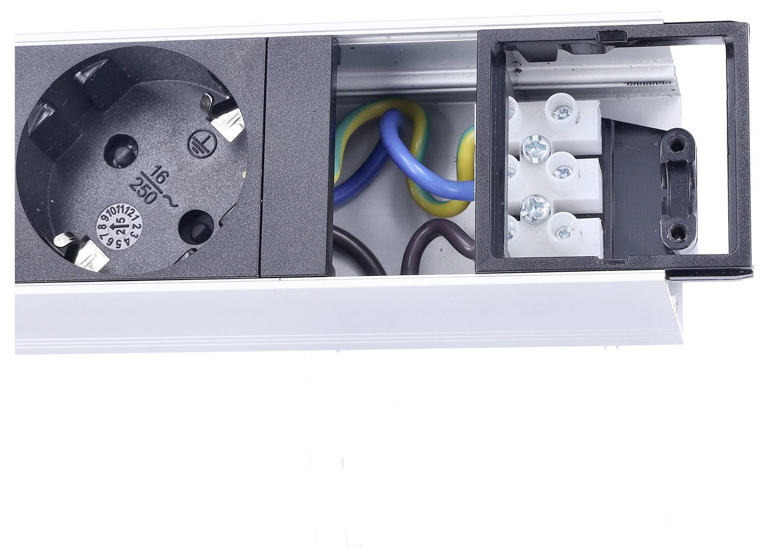 Zásuvka ve zdi s vystavěnou částí vedení ukazuje různobarevné vodiče připojené k svorkám, což svědčí o elektrické instalaci.