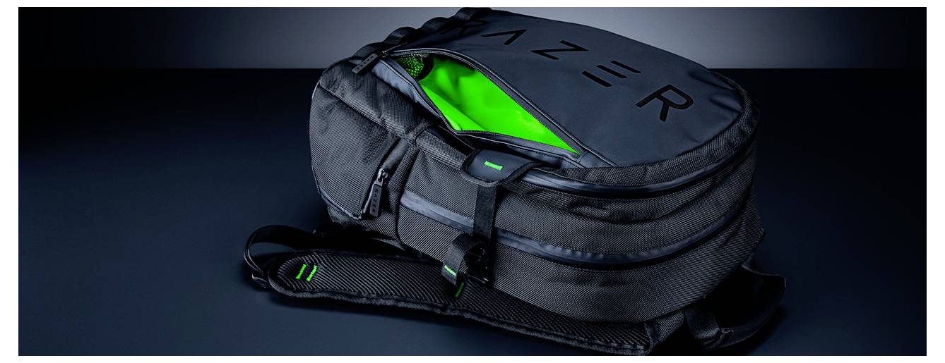 Černý batoh Razer s otevřeným hlavním oddílem, odhalující jasně zelenou vnitřnost, vystavený na tmavém povrchu.