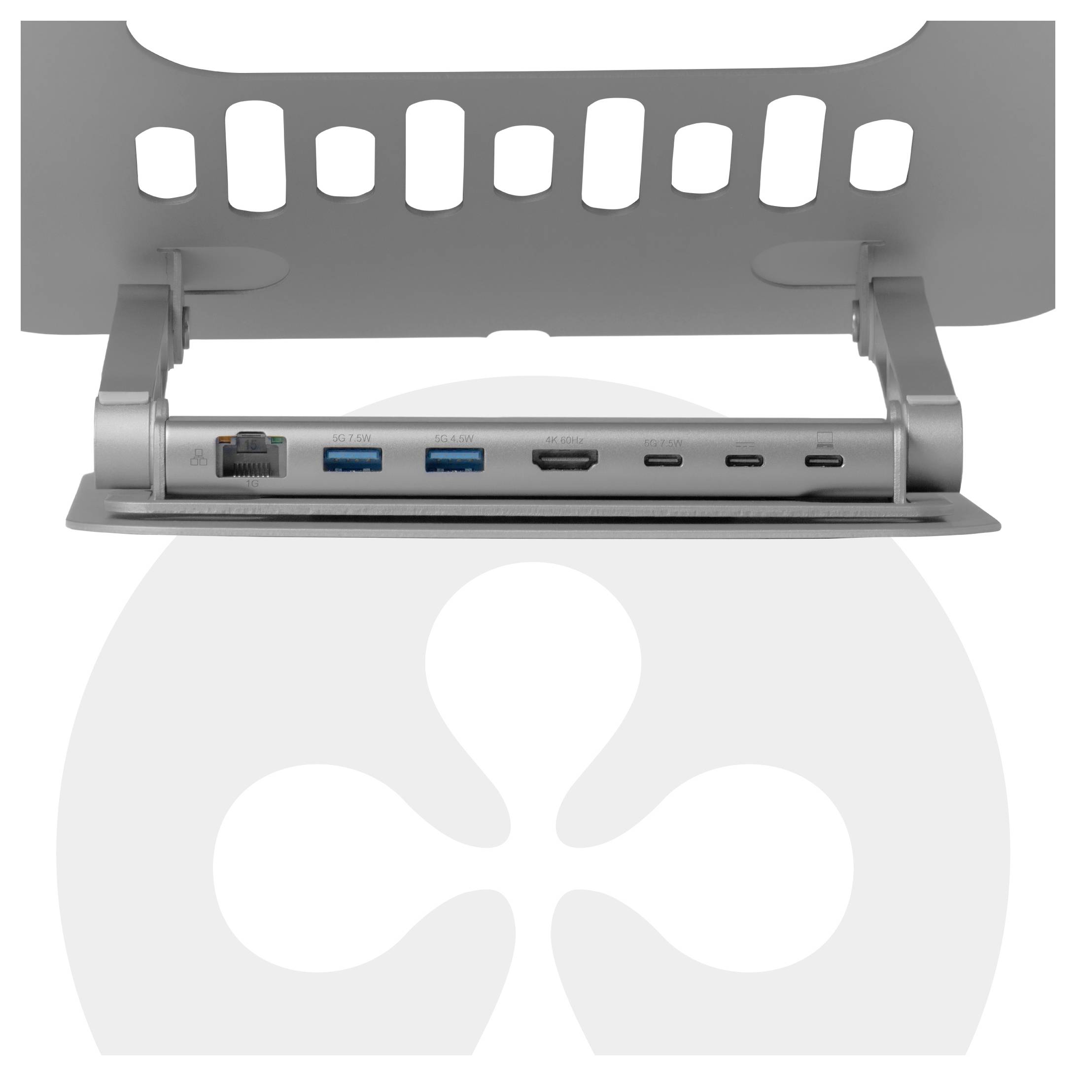 'Detailní záběr stříbrné dokovací stanice s různými porty, včetně Ethernetu, USB, HDMI a USB-C, namontované pod děrovanou plochu.'