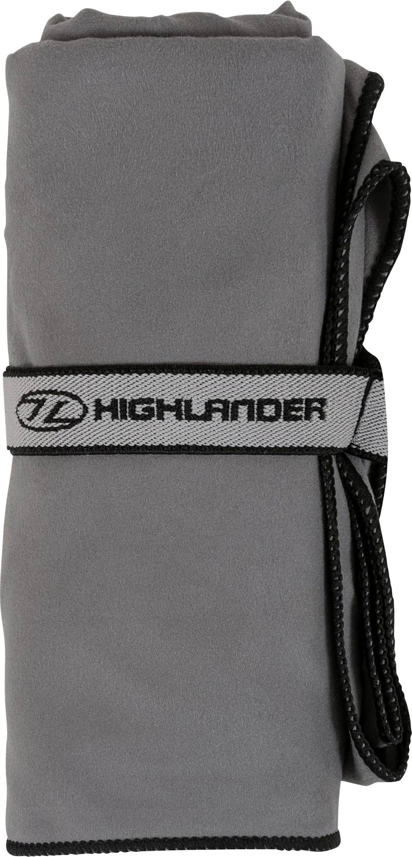 Šedý ručník svinutý a zajištěný páskem se značkou 'Highlander'.