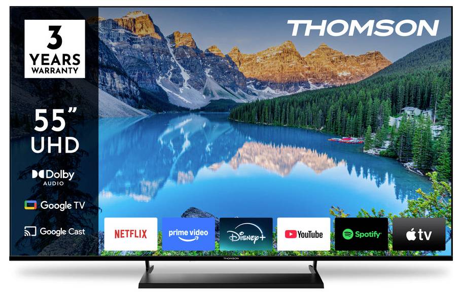 Televizor Thomson 55 palců UHD zobrazující scénu horského jezera. Mezi funkce patří 3letá záruka, Dolby Audio, Google TV, s ikonami aplikací jako Netflix a YouTube.