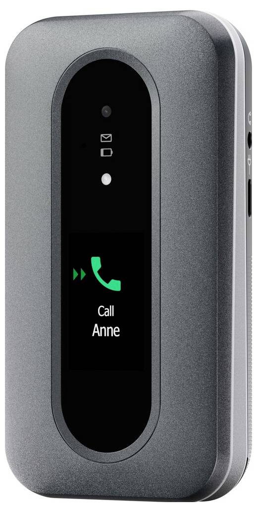 Šedý klapací telefon s malým digitálním displejem zobrazujícím zelenou ikonu telefonu a text „Zavolat Anne". Nad displejem jsou ikony pro zprávy.