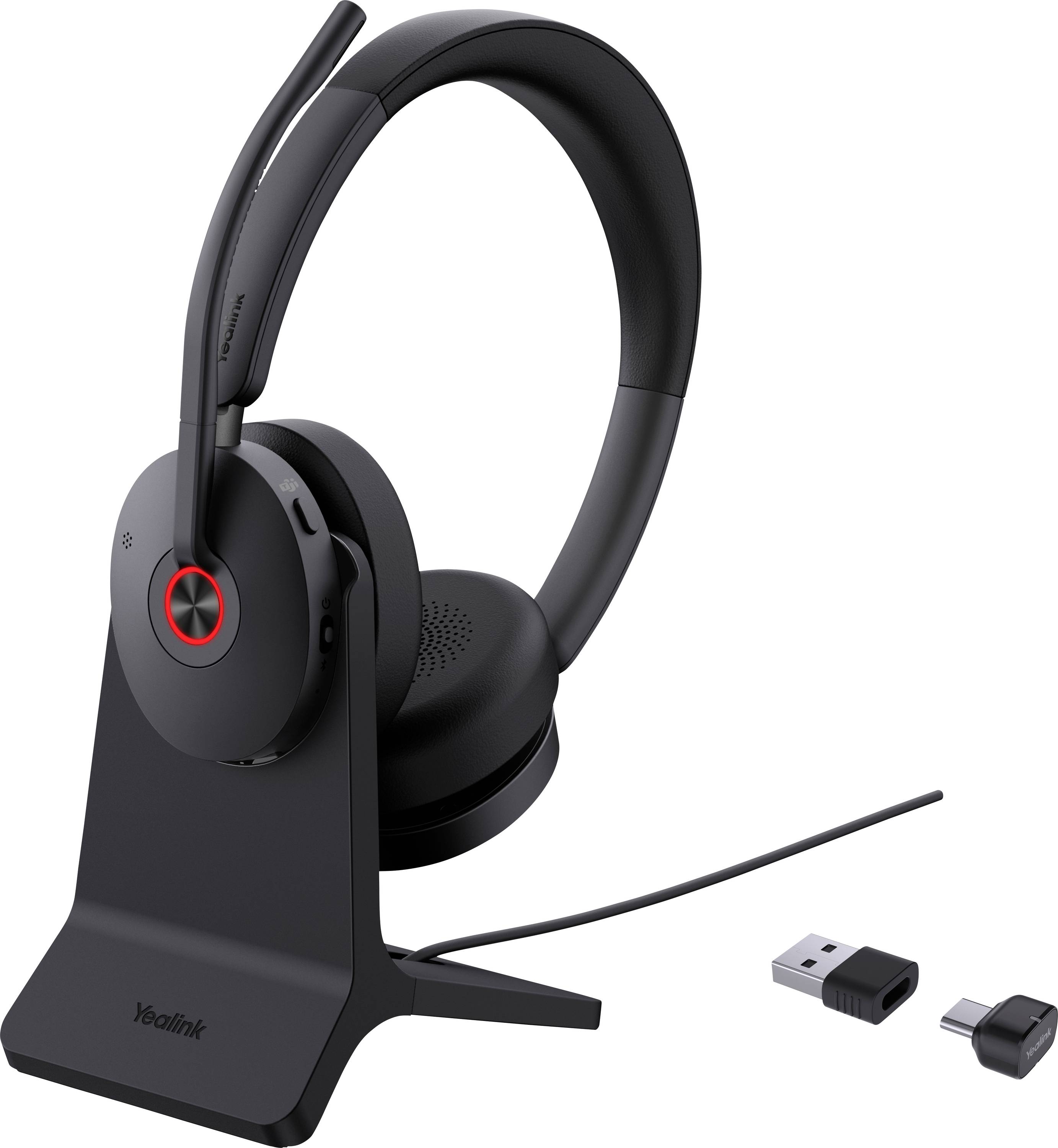 Bezdrátová sluchátka na nabíjecím stojanu včetně USB donglu a adaptéru.