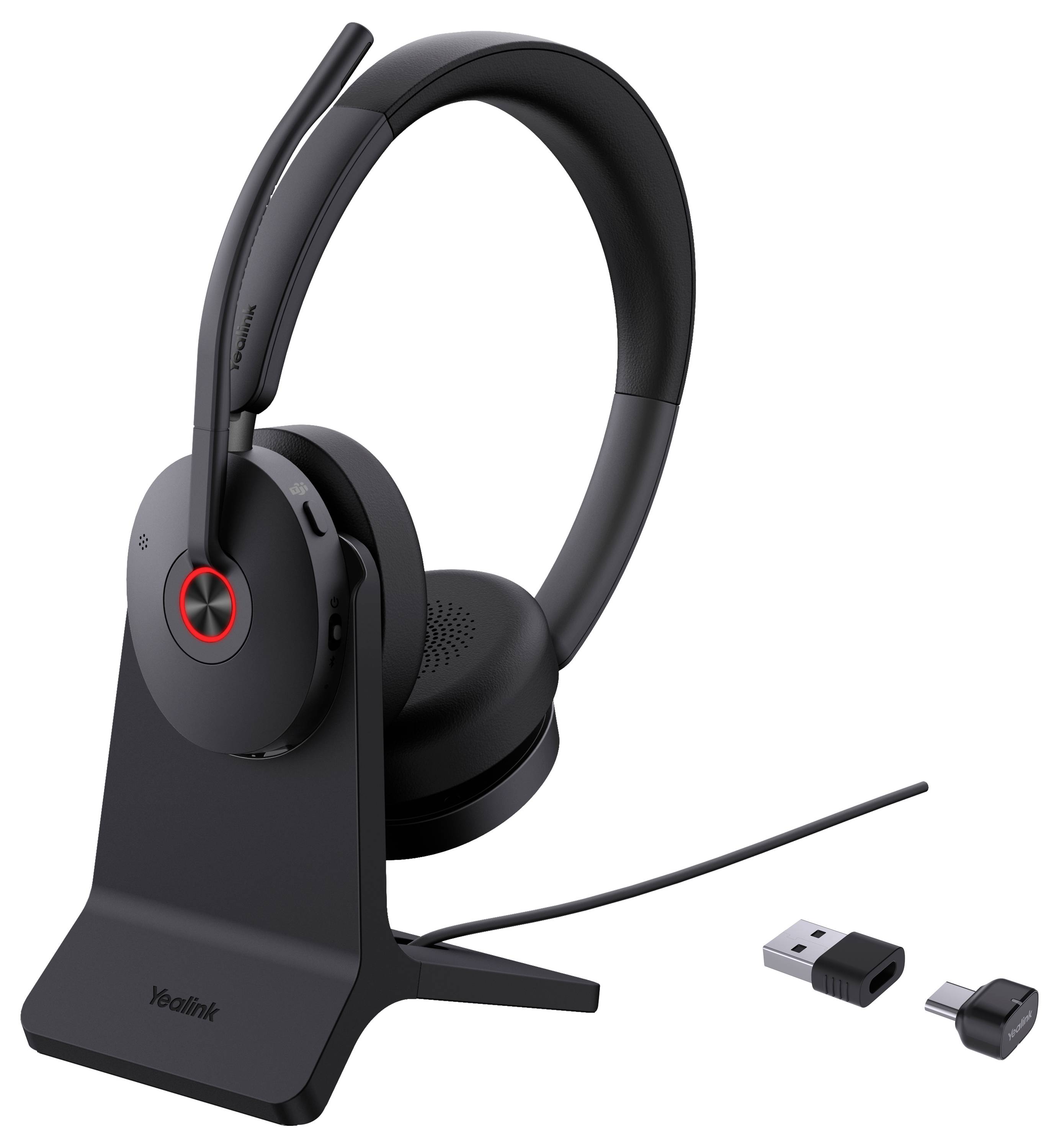 Bezdrátová černá sluchátka na nabíjecím stojanu s USB a audio konektory vedle něj.