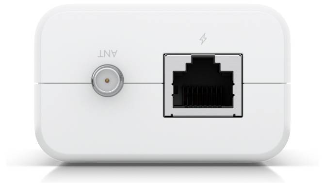 Bílé zařízení s koaxiálním portem označeným „ANT" na levé straně a portem Ethernet s ikonou blesku na pravé straně.