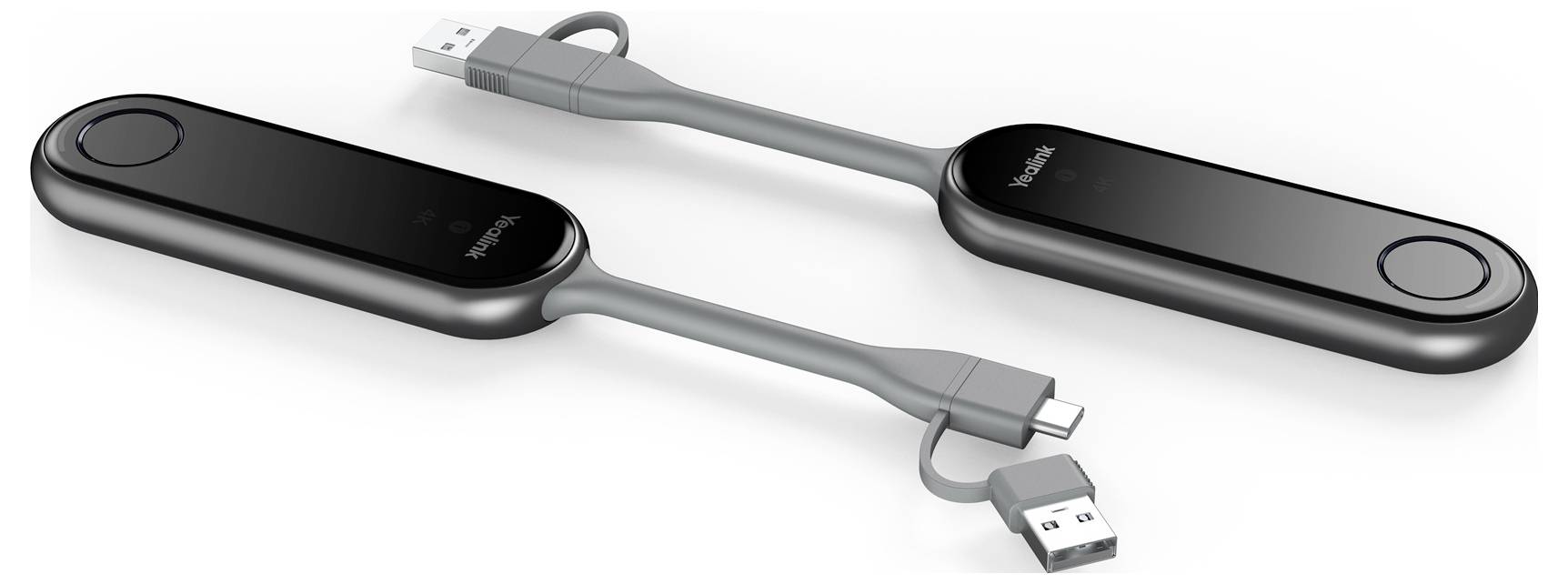 Dva černé USB kabely s oválnými adaptéry, zobrazené připojené krátkým šedým kabelem, což naznačuje zařízení pro nabíjení nebo přenos dat.