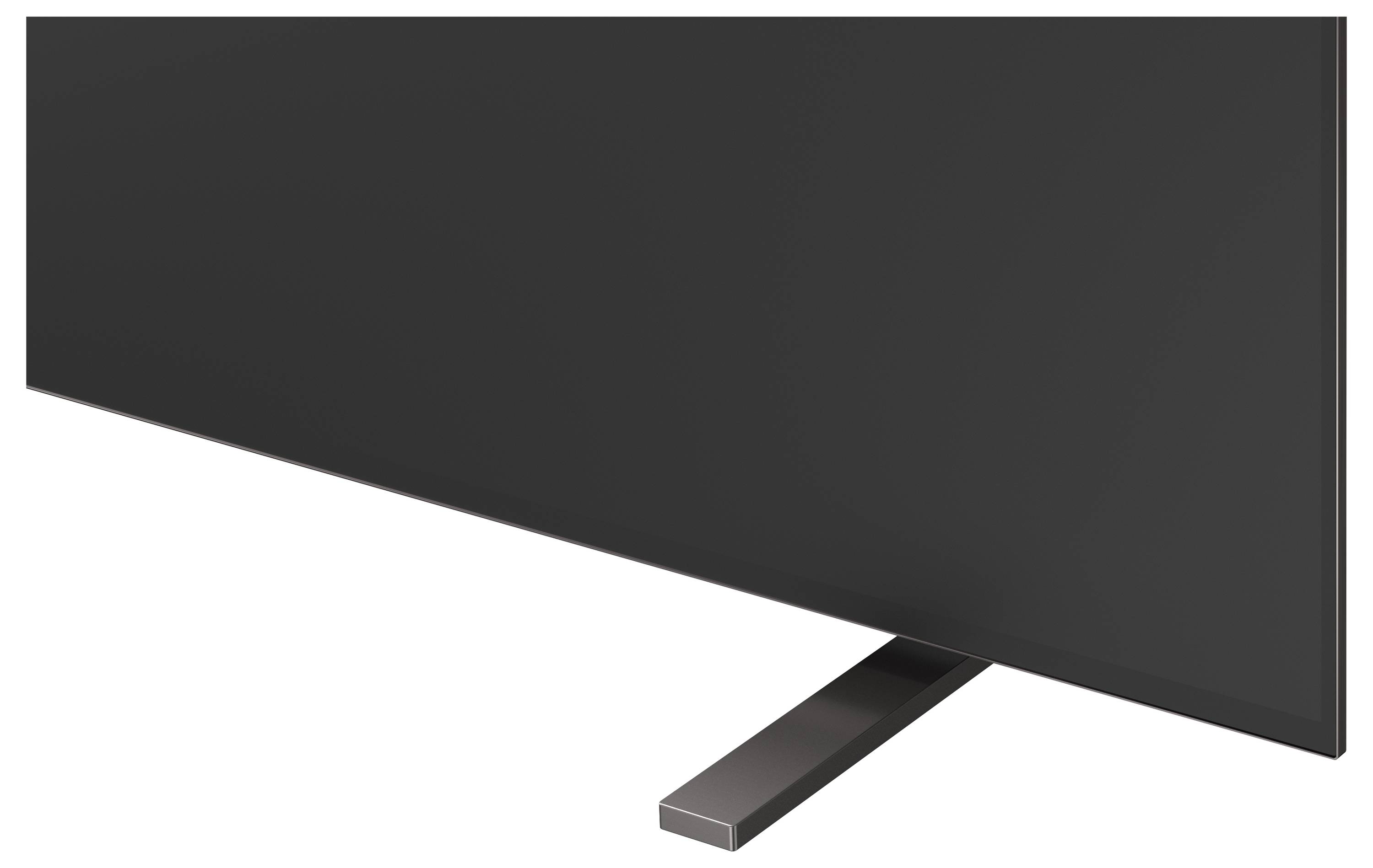 Detailní záběr na černou plochý televizor nebo monitor na stojanu, ukazující pouze dolní roh a nosnou nohu.