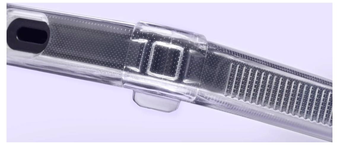 Detailní zobrazení transparentní pletené hadice s černou koncovkou a centrálním konektorem, zobrazené diagonálně na světle fialovém pozadí.